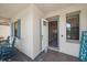 Welcoming foyer area with an open door, blue trim, and chairs on the front porch at 16810 Scuba Crest St, Wimauma, FL 33598