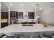 Gourmet kitchen featuring dark cabinets, stainless steel appliances, and a large quartz island at 16810 Scuba Crest St, Wimauma, FL 33598