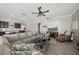 Open living space connecting to the kitchen, with a large sofa and entertainment center at 16810 Scuba Crest St, Wimauma, FL 33598