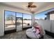 Relaxing covered patio with lounge seating and views of the private fenced backyard at 16810 Scuba Crest St, Wimauma, FL 33598