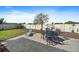 Backyard patio with an outdoor dining set and lounge chair on the paver patio at 16810 Scuba Crest St, Wimauma, FL 33598