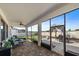 This covered patio features a paver floor, ceiling fan, and views of the fenced backyard at 16810 Scuba Crest St, Wimauma, FL 33598