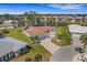 Beautiful aerial view of a well-manicured backyard overlooking a serene waterfront with lush green grass at 1714 Coral Sands Ct, Venice, FL 34293
