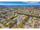 An aerial view shows this house on a waterfront, surrounded by a serene residential area at 1714 Coral Sands Ct, Venice, FL 34293