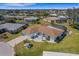 Expansive aerial view of a beautiful home with a pool, set against the backdrop of a well-kept community at 1714 Coral Sands Ct, Venice, FL 34293