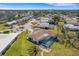 Wide aerial view showcasing a house with pool and spacious yard in a serene neighborhood at 1714 Coral Sands Ct, Venice, FL 34293