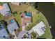 Expansive aerial view of the home with a pool, solar panels, well-manicured lawns, and lakeside access at 1714 Coral Sands Ct, Venice, FL 34293