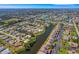 An aerial shot presents a waterfront residence nestled within a lush, tranquil community at 1714 Coral Sands Ct, Venice, FL 34293