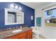 Bathroom featuring a wood vanity, granite countertop, a large mirror, and a stained-glass window at 1714 Coral Sands Ct, Venice, FL 34293