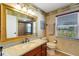 Cozy bathroom featuring a decorative mirror, granite countertop, and a glass enclosed shower at 1714 Coral Sands Ct, Venice, FL 34293