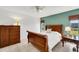 Bedroom featuring wood furniture, a ceiling fan, tile flooring, and natural light from a large window at 1714 Coral Sands Ct, Venice, FL 34293