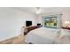 Bright bedroom with ceiling fan, and view of a screen enclosed pool area through a sliding glass door at 1714 Coral Sands Ct, Venice, FL 34293