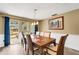 Bright dining room with wood floors, and large windows offers an inviting space for gatherings at 1714 Coral Sands Ct, Venice, FL 34293