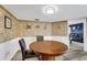 Charming eat-in kitchen features wainscoting and adjacent access to living room with leather furniture at 1714 Coral Sands Ct, Venice, FL 34293