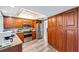 Kitchen featuring wooden cabinetry, stainless steel appliances, granite countertops and hardwood flooring at 1714 Coral Sands Ct, Venice, FL 34293