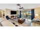 Living room with tile floors, ceiling fan, and access to the screened-in porch and pool at 1714 Coral Sands Ct, Venice, FL 34293