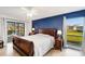 Spacious main bedroom with a large window offers natural light and views of the community pool at 1714 Coral Sands Ct, Venice, FL 34293