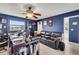 Home office space with dark blue walls, a ceiling fan, and a comfortable leather sofa at 1714 Coral Sands Ct, Venice, FL 34293