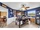 Home office with dark blue walls, decorative lighting, a ceiling fan and a large workstation at 1714 Coral Sands Ct, Venice, FL 34293