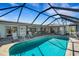 Screened in pool and lanai area with chairs and an open view of the backyard at 1714 Coral Sands Ct, Venice, FL 34293