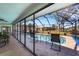 Screened in pool and lanai area with chairs and an open view of the backyard at 1714 Coral Sands Ct, Venice, FL 34293