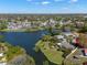 Gorgeous aerial view of houses next to a lake, houses with pools, and a road marked by a red arrow at 1940 35Th N St, St Petersburg, FL 33713