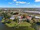 Fabulous aerial view of lakeside homes with mature trees and a red arrow pointing to a driveway at 1940 35Th N St, St Petersburg, FL 33713
