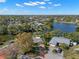 Lovely aerial view of homes surrounding a lake, lots of trees, and a driveway marked by a red arrow at 1940 35Th N St, St Petersburg, FL 33713