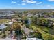 Beautiful aerial view of houses on a lake, green lawns, and a red arrow pointing to a driveway at 1940 35Th N St, St Petersburg, FL 33713