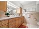 Bathroom features a vanity with wooden cabinets, a large mirror, and decorative touches at 1940 35Th N St, St Petersburg, FL 33713
