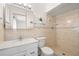 Bathroom features a shower, a vanity with a mirror, and a toilet at 1940 35Th N St, St Petersburg, FL 33713