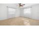 Cozy bedroom featuring tile flooring, neutral paint, and bright windows with sheer white curtains at 1940 35Th N St, St Petersburg, FL 33713