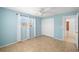 Bedroom with tile floors, blue walls, ceiling fan and closet with sliding doors at 1940 35Th N St, St Petersburg, FL 33713