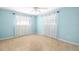 Bedroom with tile floors, pale blue walls, and bright windows at 1940 35Th N St, St Petersburg, FL 33713