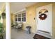 Inviting front porch featuring tile flooring, seating, and a decorative wreath on the front door at 1940 35Th N St, St Petersburg, FL 33713
