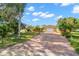 Beautiful home showcasing a brick driveway, lush landscaping, and well-maintained lawn at 1940 35Th N St, St Petersburg, FL 33713