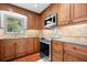 Cozy kitchen showcases custom wood cabinets, granite counters, and stainless-steel appliances at 1940 35Th N St, St Petersburg, FL 33713