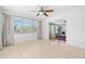 Spacious living room with neutral tile flooring, flowing into the sunroom with lots of natural light at 1940 35Th N St, St Petersburg, FL 33713