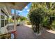 Brick patio with a partial view of the lake, white picket fence, beautiful landscaping, and shade trees at 1940 35Th N St, St Petersburg, FL 33713