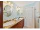 Bright bathroom with double sinks and granite countertops, plus a shower with glass doors at 202 75Th St, Holmes Beach, FL 34217