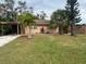 Cozy home with well-maintained lawn, mature palms, and a convenient carport at 2323 Prospect St, Sarasota, FL 34239