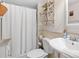 Cozy bathroom features a toilet, sink and shower/tub combo with white shower curtain at 2526 Clubhouse Dr # 203, Sarasota, FL 34232