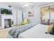 Bedroom featuring fireplace, comfortable chair, and access to screened patio at 2526 Clubhouse Dr # 203, Sarasota, FL 34232