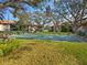 Lush community greenspace with shuffleboard court and mature landscaping at 2526 Clubhouse Dr # 203, Sarasota, FL 34232