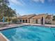 Inviting community pool with lush landscaping and plenty of space for sunbathing at 2526 Clubhouse Dr # 203, Sarasota, FL 34232