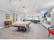 Spacious game room with billiard table, TV, and plenty of room for entertaining guests at 2526 Clubhouse Dr # 203, Sarasota, FL 34232