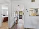 Hallway with white walls, leading to bedroom, featuring an opening to kitchen area at 2526 Clubhouse Dr # 203, Sarasota, FL 34232