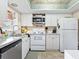 Bright kitchen featuring white appliances, ample counter space, and decorative backsplash at 2526 Clubhouse Dr # 203, Sarasota, FL 34232