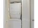 Conveniently arranged laundry area with a stacked washer and dryer unit and closet storage at 2526 Clubhouse Dr # 203, Sarasota, FL 34232