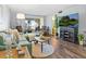 Bright living room with hardwood floors, view to an outdoor patio, comfortable furniture and a flat screen TV at 2526 Clubhouse Dr # 203, Sarasota, FL 34232